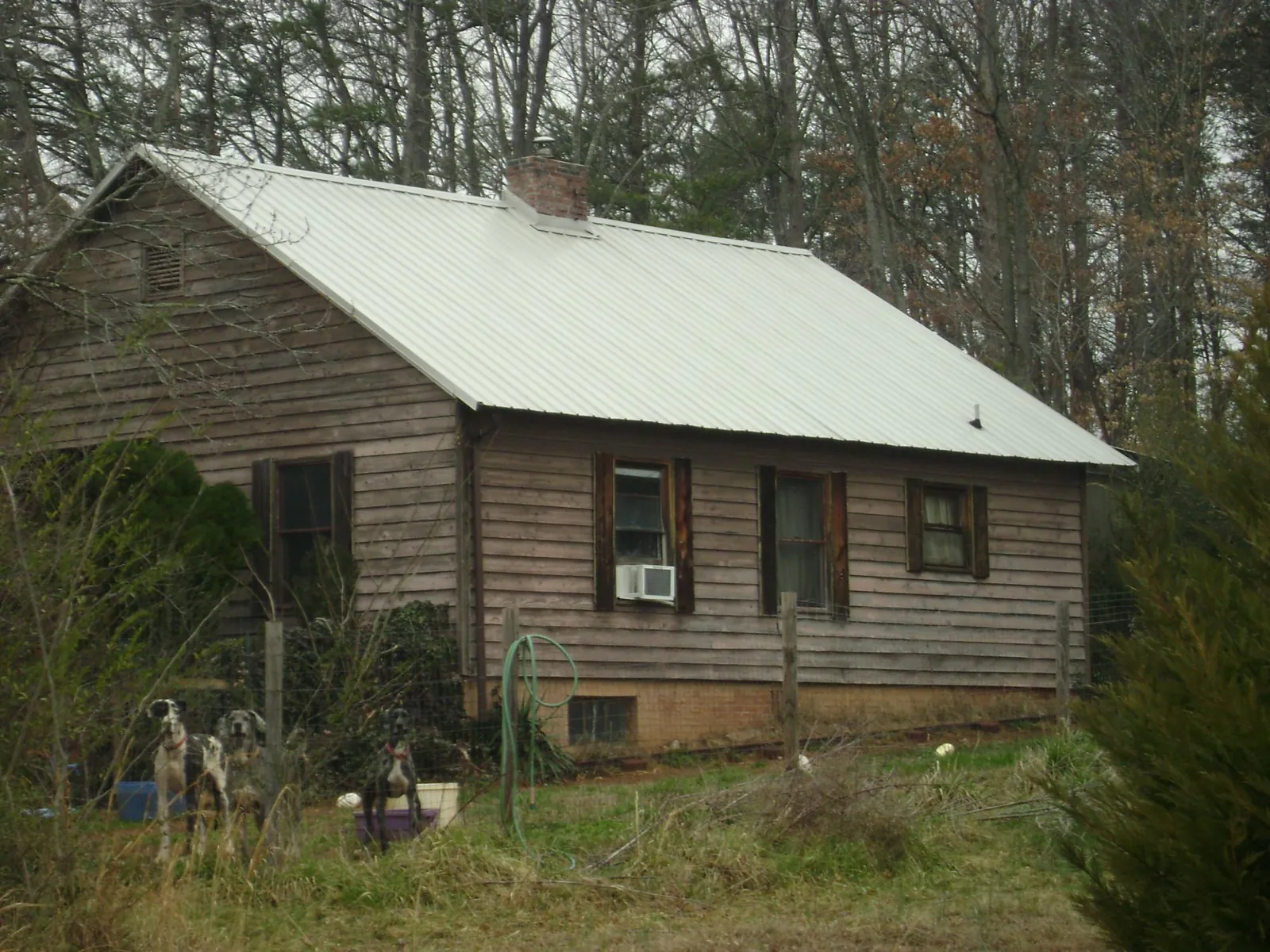 White metal roof on an old wood sided farmhouse, from a Metal Roof Installation job in Middleton